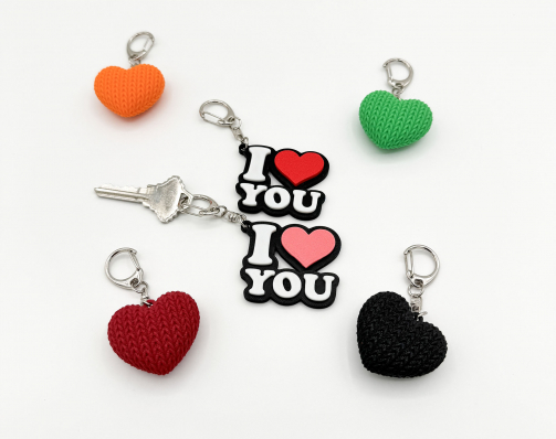 I love you keychains featuring a 3D printed red and pink (or any color you want) hearts, white letters, and a silver swivel clasp.