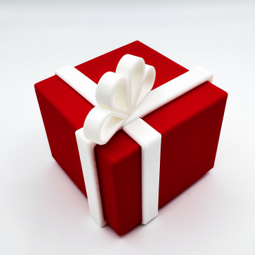 Red 3D printed puzzle gift box with white locking ribbon bow.