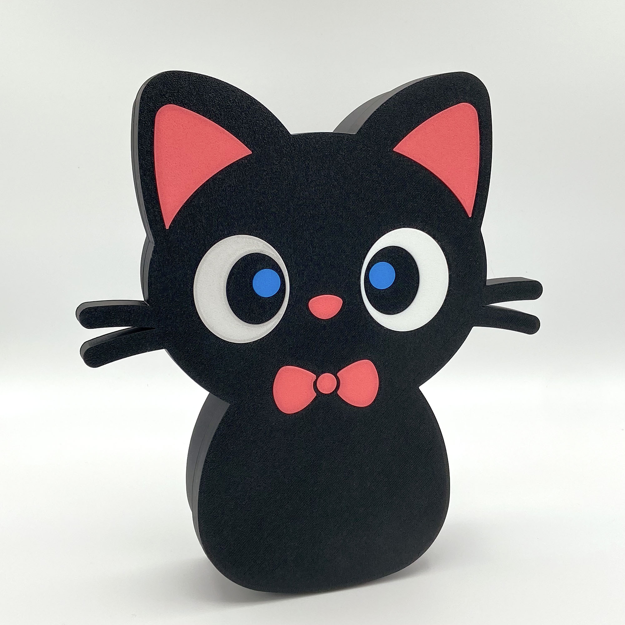 Front-facing view of a standing cute black cat box with a pink bow tie and big blue eyes.