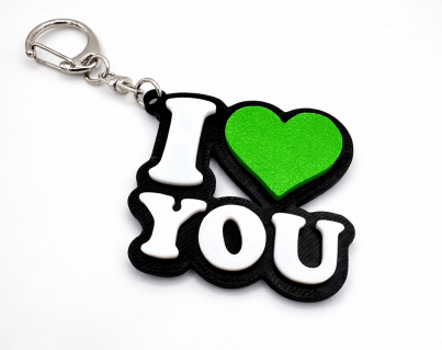 I love you keychain featuring a 3D printed green (St Patrick's Day version) heart, white letters, and a silver swivel clasp.