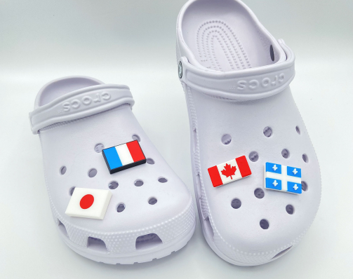 Collection of 3D printed flag charms: Canada, France, Japan, and Québec.
