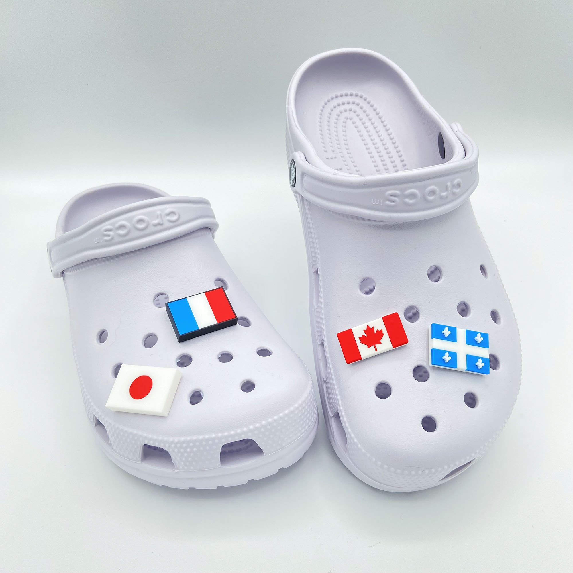 Collection of 3D printed flag charms: Canada, France, Japan, and Québec.