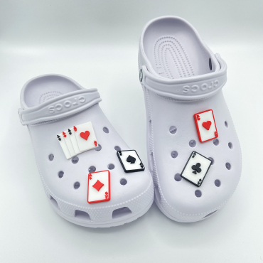 A complete set of five 3D printed Ace playing card charms on white shoes.