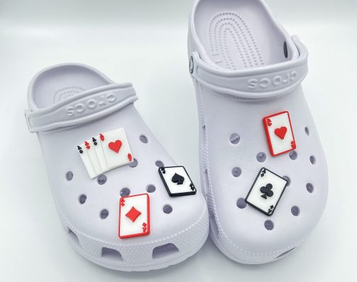 A complete set of five 3D printed Ace playing card charms on white shoes.