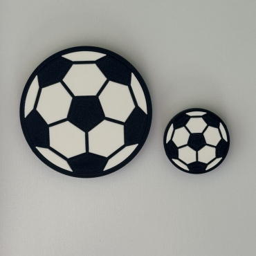 Two flat black and white soccer ball magnets in 28mm and 14mm radius sizes side-by-side.